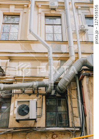 building with large air conditioner on wall. Ventilation air conditioning. cooling down in summer. building with large air conditioner on wall. Ventilation air conditioning. cooling down in summer. 127459356