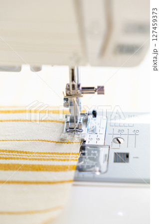sewing machine with a cloth under a steel needle. manufacture of clothing. sewing machine with a cloth under a steel needle. manufacture of clothing. 127459373