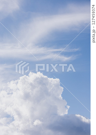 Fluffy white cloud in the blue sky. clear and cloudy weather, possible precipitation, rain. 127459374