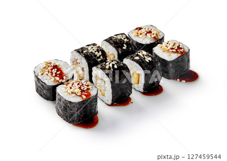 Delicious sushi rolls with eel and sesame seeds drizzled with unagi sauce on white background 127459544