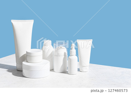 Blank cosmetic containers on light blue background Blank cosmetic containers on light blue background 127460573