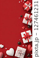 Festive Red Background With White and Brown Gifts and Heart-Shaped Chocolates Arranged for Celebration. 127461231