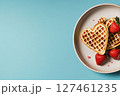 Heart-shaped Waffles With Fresh Strawberries on a Blue Background for a Delightful Breakfast. 127461235