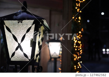 Glowing street lights and festive garlands. 127462382