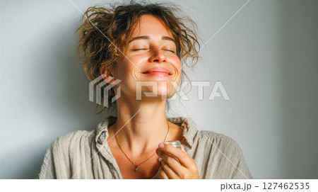Joyful woman enjoying a moment of tranquility with a small cup in a serene indoor setting Joyful woman enjoying a moment of tranquility with a small cup in a serene indoor setting 127462535