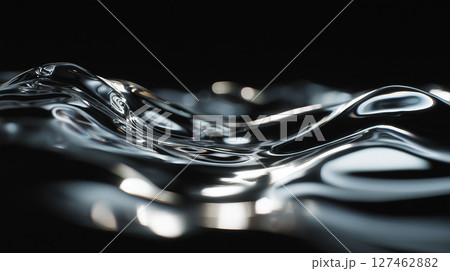 Wavy surface of liquid mercury reflecting light on dark background, creating abstract organic shapes 127462882