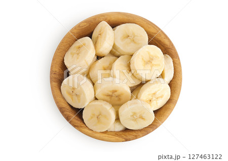 peeled banana pieces in wooden bowl isolated on white background. Top view. Flat lay. peeled banana pieces in wooden bowl isolated on white background. Top view. Flat lay. 127463122