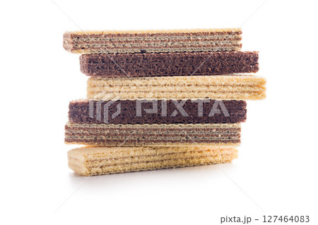 Sweet wafers filled with chocolate and vanilla cream isolated on white background. Sweet wafers filled with chocolate and vanilla cream isolated on white background. 127464083