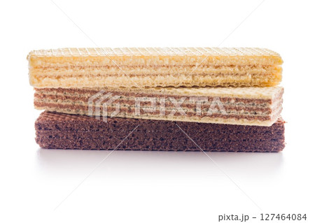 Sweet wafers filled with chocolate and vanilla cream isolated on white background. 127464084