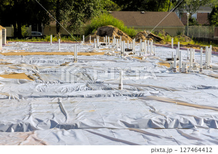 Construction site prepared with sheeting pipes for future building project in sunny weather 127464412
