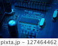 Here is a detailed view of a bluelit circuit board that showcases intricate and complex electronic components 127464462