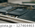 A closeup, detailed view showcasing lithiumion batteries integrated into the intricate internal structure of a laptop 127464463