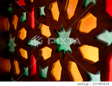 Window with Arabic colored lattice, soft curtain dropped on side and dim light 127465610