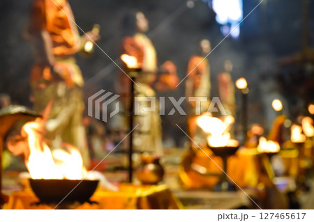 Pujaris or Indian priests performing Aarti ceremony on banks of Ganges in crowd Pujaris or Indian priests performing Aarti ceremony on banks of Ganges in crowd 127465617