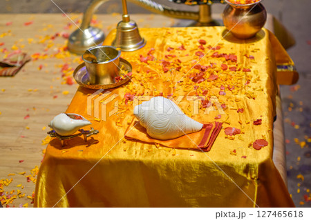 Objects of Aarti ceremony used by Pujaris on Ganges on golden table with petals 127465618