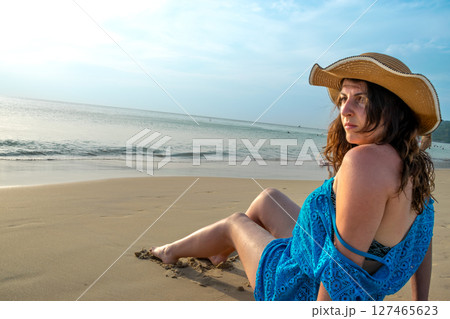 Rear view of young model observing horizon with hat on beach at Patong beach Rear view of young model observing horizon with hat on beach at Patong beach 127465623