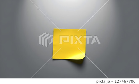 A vibrant yellow sticky note isolated against a soft grey backdrop, with captivating lighting 127467706