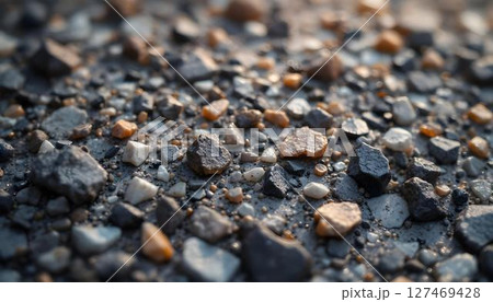 Close-up view of textured rocks and gravel scattered on the ground, showcasing natural earth materials 127469428