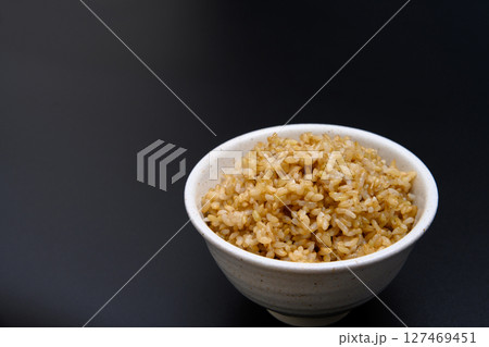 黒背景の茶碗によそう玄米ご飯 黒背景の茶碗によそう玄米ご飯 127469451