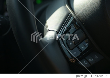 interior view of car with black leather, steering wheel with button interior view of car with black leather, steering wheel with button 127470402