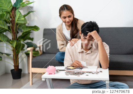 Navigating Financial Stress. Young couple managing expenses with concern. 127470678