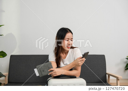 Travel Preparation with Smartphone. Woman excitedly planning her next adventure. Travel Preparation with Smartphone. Woman excitedly planning her next adventure. 127470720