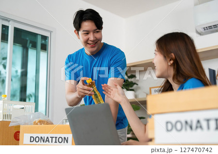 Donation and Volunteer Work. Young adults collaborating on a community donation project. Donation and Volunteer Work. Young adults collaborating on a community donation project. 127470742