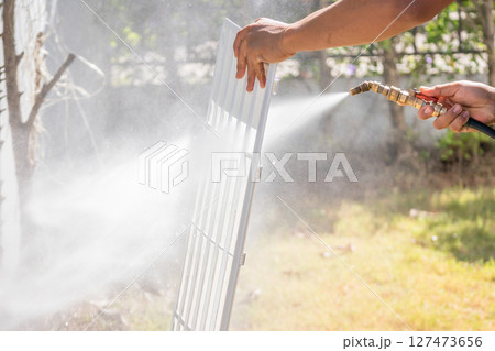 air conditioning filter cleaning with water spray air conditioning filter cleaning with water spray 127473656