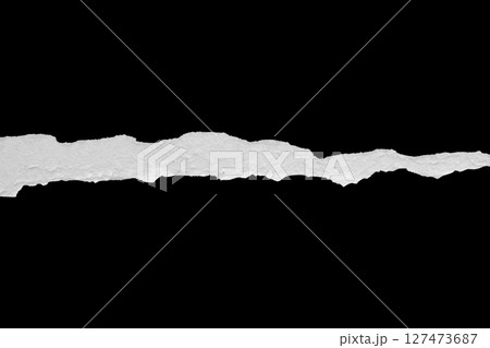 Ripped torn paper edges isolated on black background 127473687