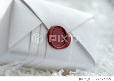 Wax seal stamp on white paper wrap packaging parcel box 127473709
