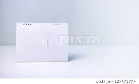 A blank white calendar on a clean surface, symbolizing fresh starts, future planning, scheduling, and key dates. Concepts of time management, productivity, and goal setting in any project or year. A blank white calendar on a clean surface, symbolizing fresh starts, future planning, scheduling, and key dates. Concepts of time management, productivity, and goal setting in any project or year. 127473777