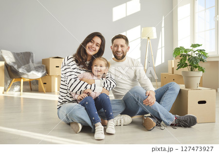 Happy family of three members enjoying Moving Day, relocate to new apartment 127473927
