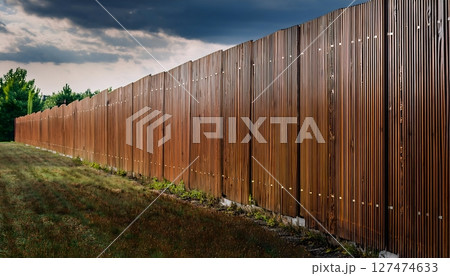 Long Wooden Privacy Fence under Stormy Sky Long Wooden Privacy Fence under Stormy Sky 127474633
