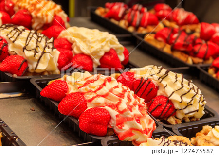 Belgian waffles with colorful sweet toppings and fruits for sale in Brussels, Belgium Belgian waffles with colorful sweet toppings and fruits for sale in Brussels, Belgium 127475587