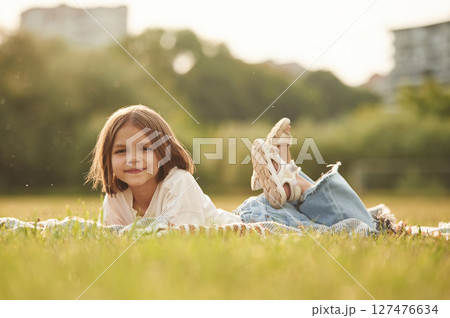 Little girl is on the summer field at daytime 127476634