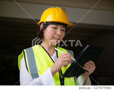 factory woman workers or technicians civil Engineer or Architecture project management using tablet at work. 127477068
