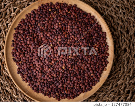 Organic uncooked seeds dark red brown lentils. Organic uncooked seeds dark red brown lentils. 127477084