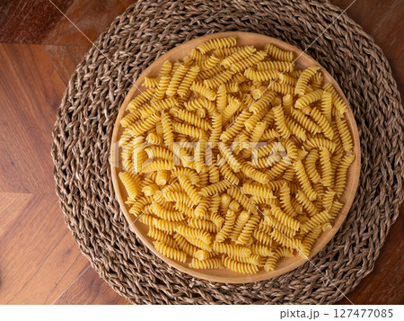 Raw Fusilli Spiral spaghetti pasta pattern background. Raw Fusilli Spiral spaghetti pasta pattern background. 127477085