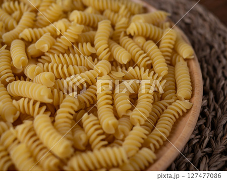Raw Fusilli Spiral spaghetti pasta pattern background. Raw Fusilli Spiral spaghetti pasta pattern background. 127477086
