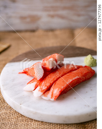 Fresh crab sticks surimi set on white plate with wasibi. 127477396