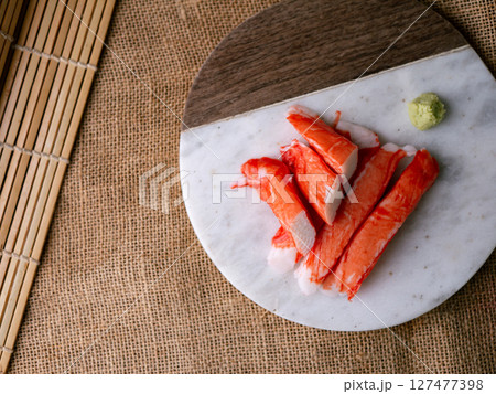Fresh crab sticks surimi set on white plate with wasibi. 127477398