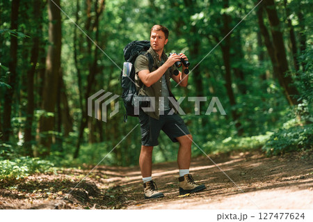 Tourist in summer forest. Conception of exploration and leisure 127477624