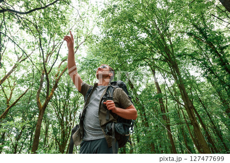 In sunglasses. Tourist in summer forest. Conception of exploration and leisure In sunglasses. Tourist in summer forest. Conception of exploration and leisure 127477699