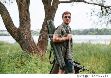 Tourist is outdoors near the lake. Conception of exploration and leisure 127477714