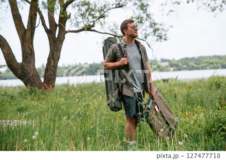 Tourist is outdoors near the lake. Conception of exploration and leisure 127477718