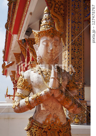 Intricate Statue of a Serene Figure in Thailand's Ornate Temple Setting 127478767