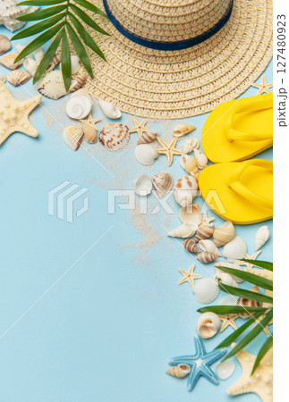 Beach accessories creating summer holiday mood on blue background 127480923