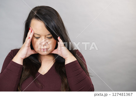 Worried woman having painfull headache 127481367