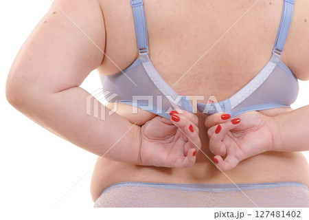 Woman back view putting on her bra lingerie. Woman back view putting on her bra lingerie. 127481402