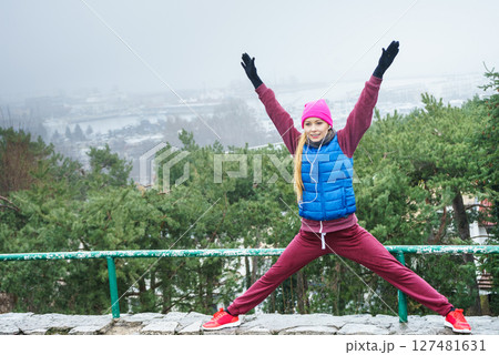Woman exercising outside during autumn 127481631